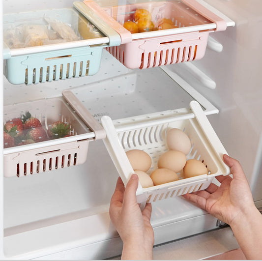 Fridge organizer with compartments holding fruits, vegetables, and eggs.