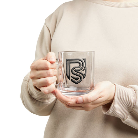 Person holding a clear mug with a logo, wearing a beige sweater.