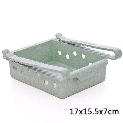 Green plastic basket with handles on a white background