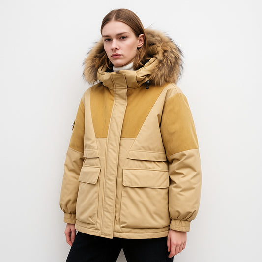 Person wearing a beige and brown winter jacket with fur hood on a white background