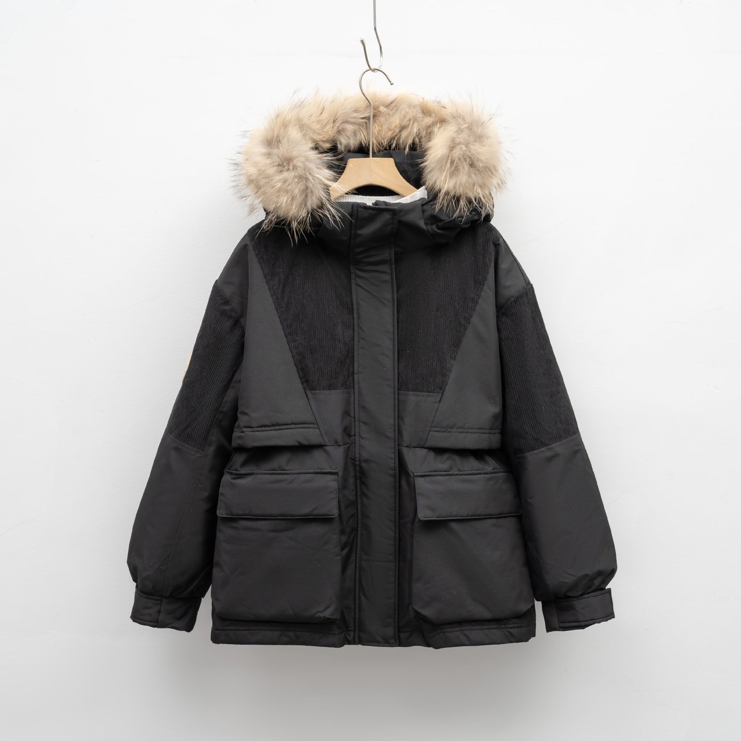 Black winter jacket with fur-lined hood on a white background