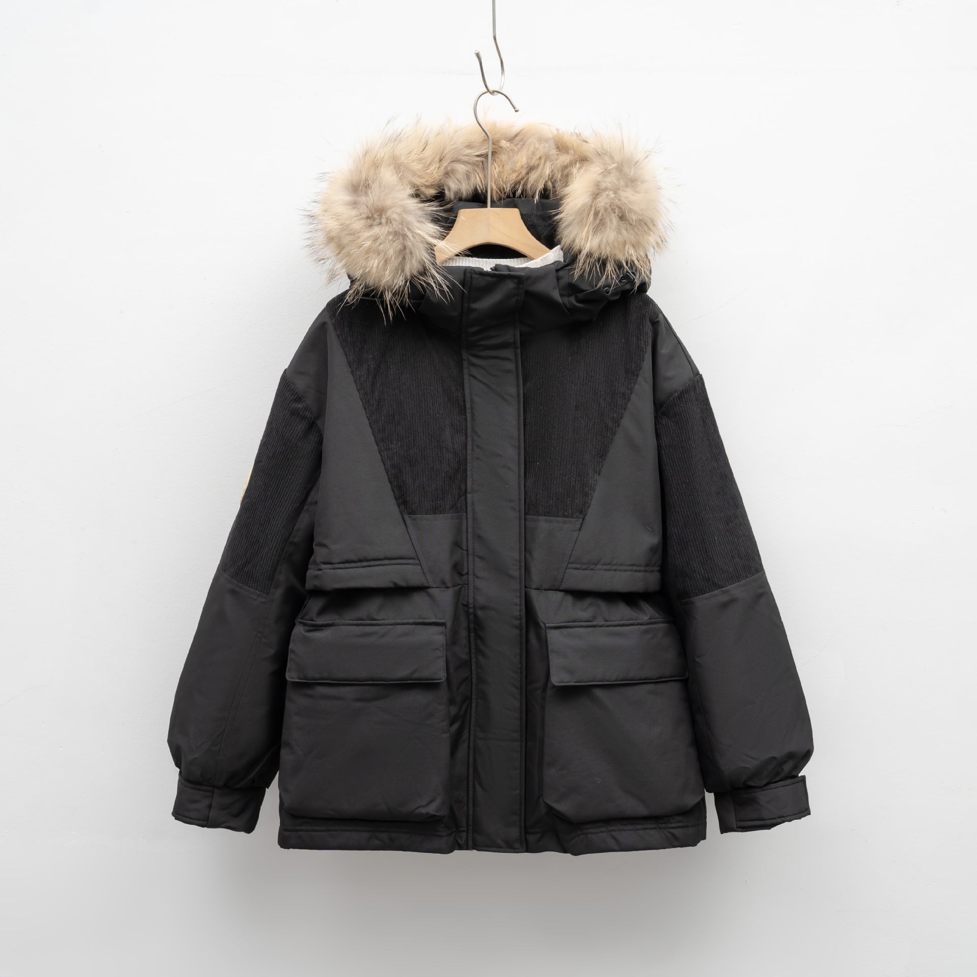 Black winter jacket with fur-lined hood on a white background
