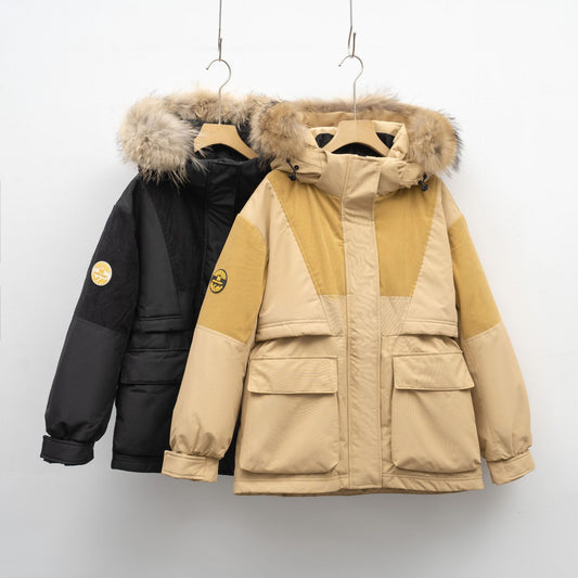 Two winter jackets, one black and one beige with fur hood, hanging on a white wall.
