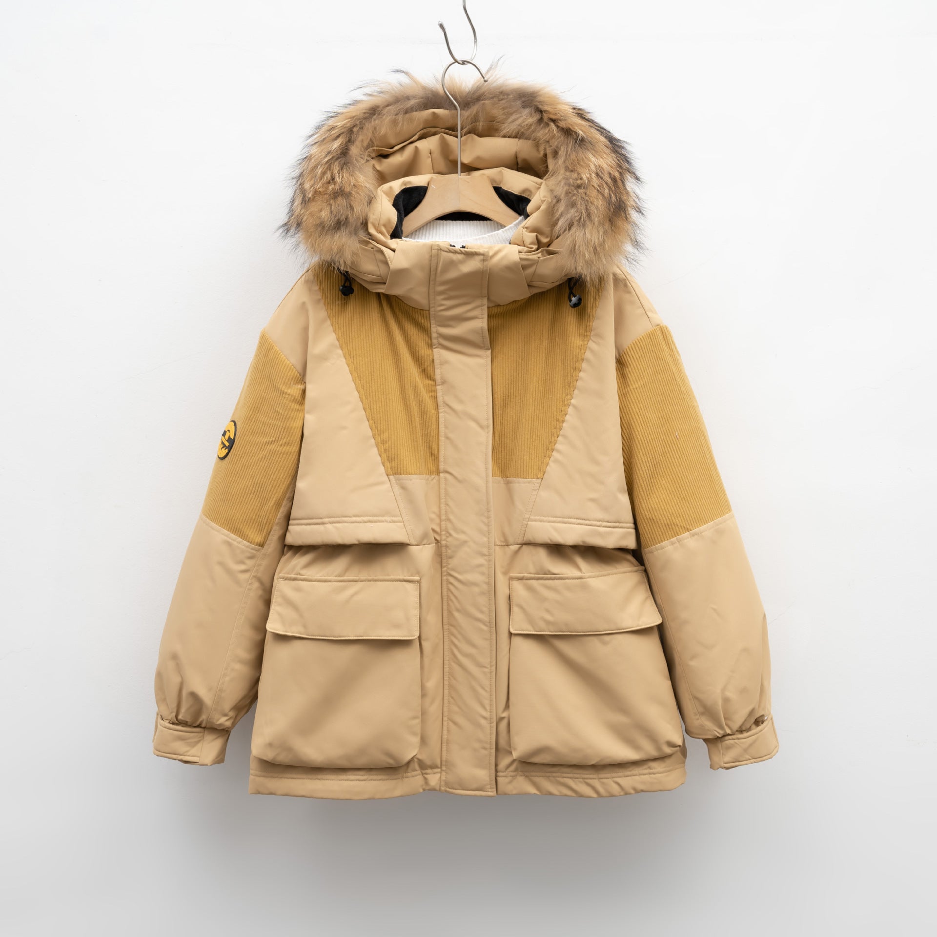 Beige and brown winter coat with fur hood on a white background